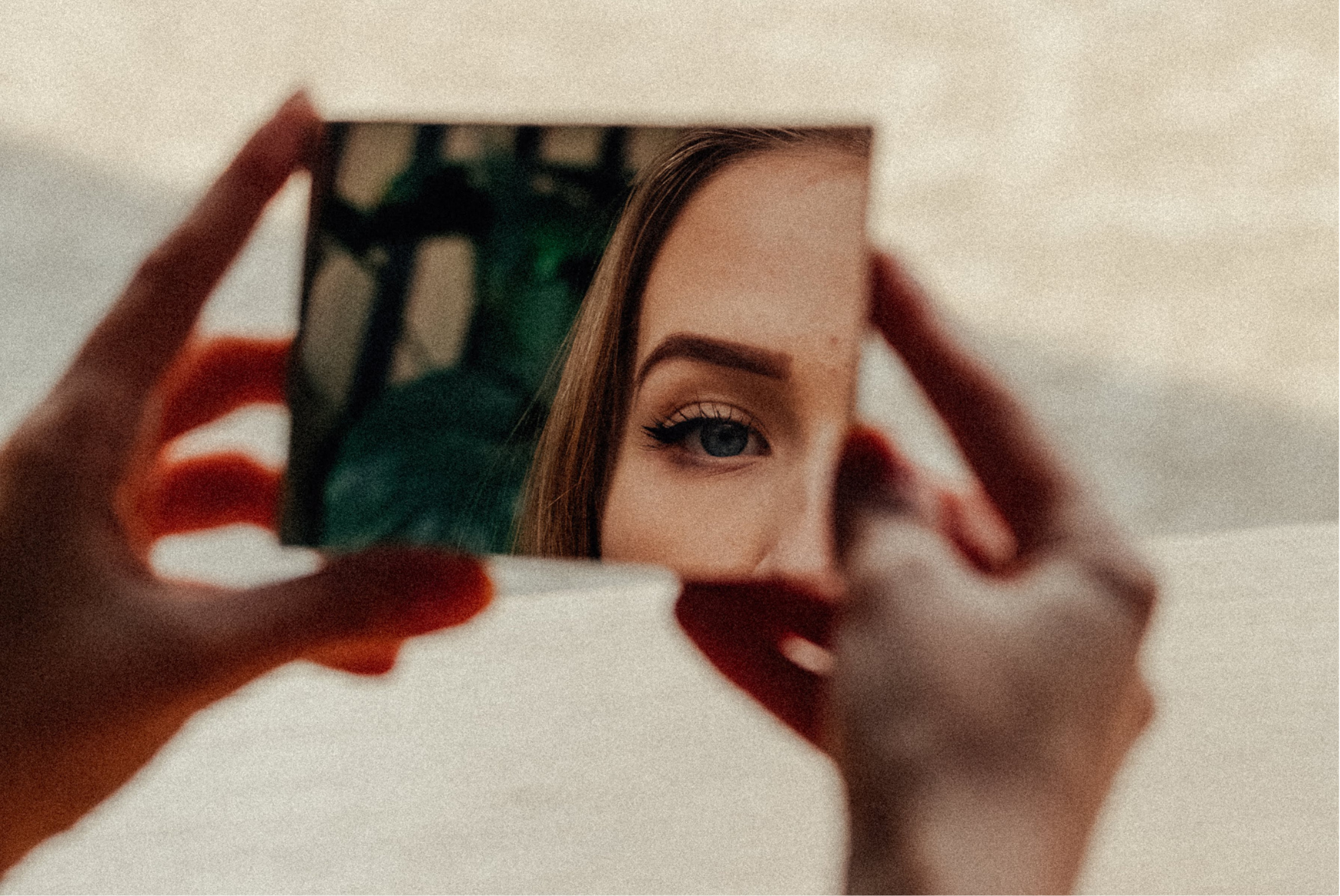 A woman looking in the mirror with a thoughtful expression